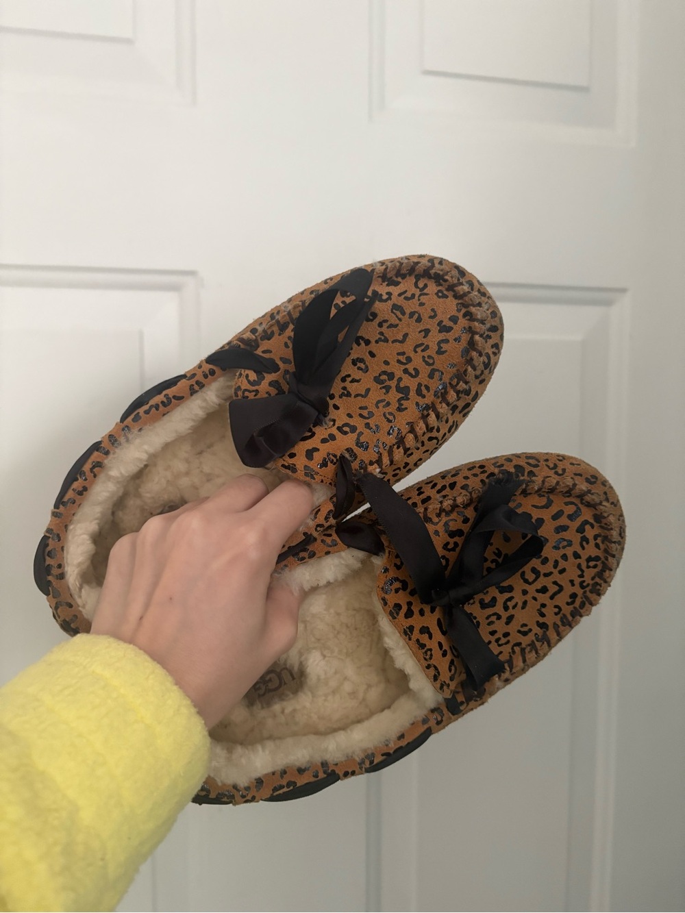 UGG women’s Leopard Print Faux-Fur Lined Slip-Ons in Brown and Black